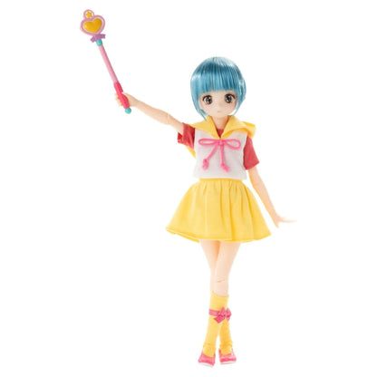 Yuu Morisawa from Creamy Mami, the Magic Angel doll with short blue hair, wearing a yellow skirt, white top with red sleeves, and pink bow details, holding a pink and yellow wand against a plain white background.