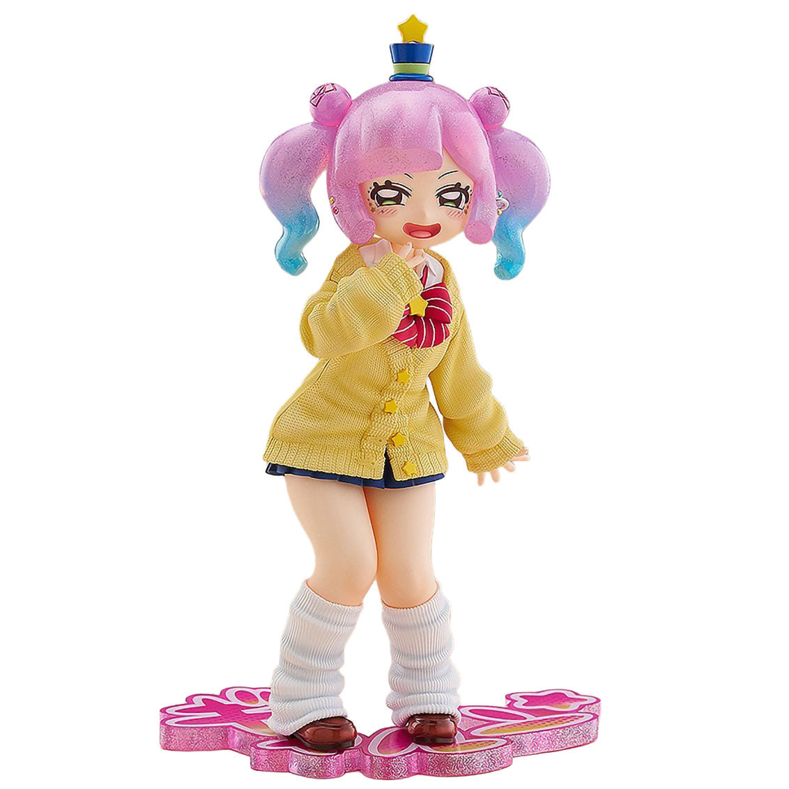 A collectible anime figurine of Puniru from Puniru Is a Kawaii Slime with pink pigtails and a blue-and-yellow crown, wearing a yellow cardigan, dark blue skirt, white knee-high socks, and brown shoes, posed on a pink decorative base against a plain white background.