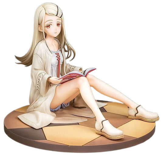 Figurine of a character sitting on a floor reading a book