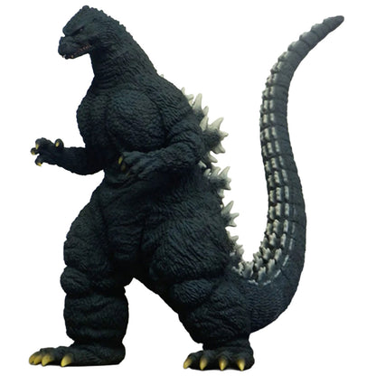 Godzilla figurine in a dignified stance, featuring textured dark gray and black skin with white spines and yellow claws, isolated on a white background.