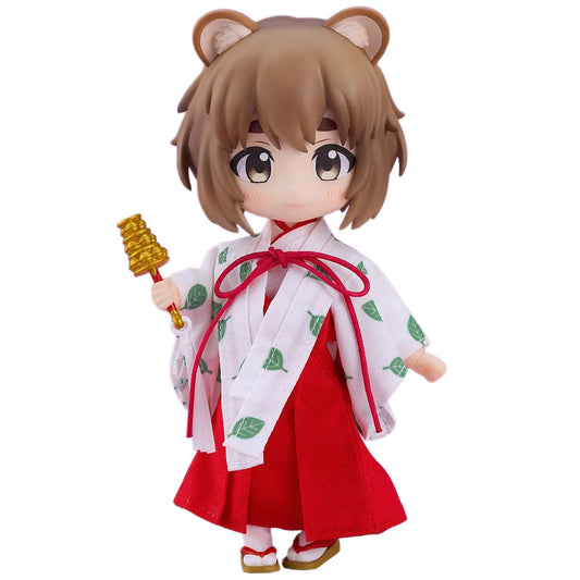 A chibi-style Tanuki Miko: Yui figurine with brown hair and bear ears, wearing a white robe with green leaf prints and a red skirt, holding a golden object, on a plain white background.