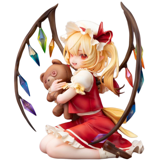 A detailed anime figurine of Flandre Scarlet from Touhou Project in a red dress with a white frill, kneeling and holding a brown teddy bear. She is framed by curved brown branches with hanging multicolored gem-like ornaments, set against a plain white background.
